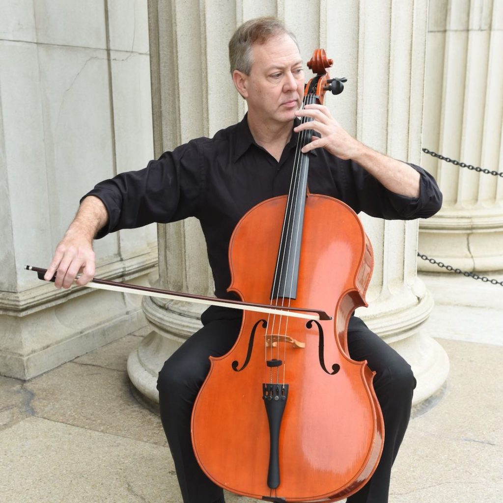 Thomas Shoebotham playing a cello.